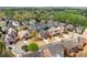 A high angle view of a neighborhood featuring diverse architectural styles, landscaping, and a green backdrop at 426 Vera Park Pl, Alpharetta, GA 30022