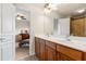 Bathroom with a dual vanity, mirrors, and views to adjacent bedroom and bathroom at 426 Vera Park Pl, Alpharetta, GA 30022