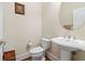 Elegant half bathroom with pedestal sink and classic fixtures at 426 Vera Park Pl, Alpharetta, GA 30022