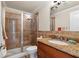 Bathroom featuring tiled shower, granite countertop and wood cabinets at 426 Vera Park Pl, Alpharetta, GA 30022