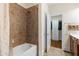 Bathroom featuring a bathtub with tiled walls and showerhead and an open doorway to the walk-in closet at 426 Vera Park Pl, Alpharetta, GA 30022