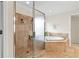 Bathroom featuring a glass shower, a tub, and neutral tile at 426 Vera Park Pl, Alpharetta, GA 30022