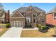 Beautiful brick home with manicured lawn and two-car garage offers classic suburban appeal and great curb appeal at 426 Vera Park Pl, Alpharetta, GA 30022