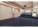 Home theater with projector and seating on a riser with star-patterned carpeting at 426 Vera Park Pl, Alpharetta, GA 30022