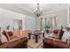 Bright living room featuring hardwood floors, a decorative chandelier, and large windows, ideal for relaxation and Gathering time at 426 Vera Park Pl, Alpharetta, GA 30022