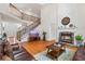 Elegant living room featuring a fireplace, hardwood floors, and a grand staircase leading to the upper level at 426 Vera Park Pl, Alpharetta, GA 30022
