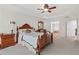 Spacious main bedroom with a ceiling fan, carpet flooring, and wood furniture at 426 Vera Park Pl, Alpharetta, GA 30022