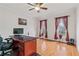 Bright home office with hardwood floors, large windows with curtains, and a classic wooden desk at 426 Vera Park Pl, Alpharetta, GA 30022