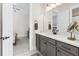 Bathroom featuring gray cabinets, a white countertop, a decorative mirror, and views to the adjacent bedroom at 432 Horizon Trl, Canton, GA 30114