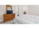 Relaxing bedroom featuring a wooden dresser with a TV and a comfortable bed with a patterned comforter at 432 Horizon Trl, Canton, GA 30114