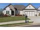 Charming home with a well-manicured lawn, complemented by stone and brick accents and a 2 car garage at 432 Horizon Trl, Canton, GA 30114