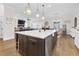 Open-concept kitchen island with seating and a view into the living area, perfect for entertaining at 432 Horizon Trl, Canton, GA 30114