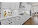 Well-equipped kitchen with white cabinets, stone countertops, a gas cooktop, and stainless steel appliances at 432 Horizon Trl, Canton, GA 30114