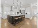 Stylish kitchen features a center island with seating, white cabinetry, and hardwood flooring throughout at 432 Horizon Trl, Canton, GA 30114