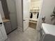 Laundry area with gray cabinets, modern washer and dryer, and a convenient entryway to a mudroom area at 432 Horizon Trl, Canton, GA 30114