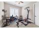 Bright office space with exercise equipment, a computer desk and chair, and ample natural light from the window at 432 Horizon Trl, Canton, GA 30114