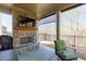 Back patio with an outdoor fireplace, a mounted television, and outdoor seating overlooking the backyard at 432 Horizon Trl, Canton, GA 30114