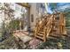 Backyard features a brick patio, stairs to a deck, and a bench at 51 Ivy Chase Ne, Atlanta, GA 30342