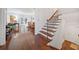 Hallway featuring wood floors, stairs, and an open view to a living room and an outdoor space at 51 Ivy Chase Ne, Atlanta, GA 30342