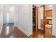 Hallway with wood floors, an open view to a kitchen, and a glass door to the wine cellar at 51 Ivy Chase Ne, Atlanta, GA 30342