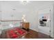 Hallway leading to a office with a wood chest, rug, and staircase at 51 Ivy Chase Ne, Atlanta, GA 30342