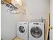 Compact laundry room with modern washer and dryer, plus convenient shelving for storage at 51 Ivy Chase Ne, Atlanta, GA 30342