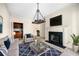 Cozy living room with decorative chandelier, fireplace, and comfortable seating at 51 Ivy Chase Ne, Atlanta, GA 30342