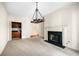 Open living room featuring decorative chandelier and fireplace at 51 Ivy Chase Ne, Atlanta, GA 30342