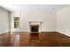Spacious living room featuring hardwood floors, a fireplace, detailed trim, and large windows at 51 Ivy Chase Ne, Atlanta, GA 30342