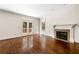 Bright living room featuring a fireplace, hardwood floors, and access to the outdoor deck at 51 Ivy Chase Ne, Atlanta, GA 30342