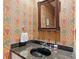 Charming powder room with designer wallpaper and granite countertop at 51 Ivy Chase Ne, Atlanta, GA 30342