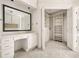 Spacious walk-in closet with custom shelving, cabinets, and a vanity area at 51 Ivy Chase Ne, Atlanta, GA 30342