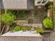 Aerial view of the backyard with a stone pathway, a detached garage, lush landscaping, and a screened-in porch at 1054 Euclid Ne Ave, Atlanta, GA 30307
