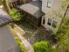 Aerial view of the backyard featuring lush greenery, stone pathways, a charming screened-in porch, and a detached garage at 1054 Euclid Ne Ave, Atlanta, GA 30307