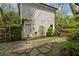 Charming backyard with a stone pathway, well-manicured garden, string lights, and a detached garage at 1054 Euclid Ne Ave, Atlanta, GA 30307
