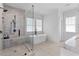 Modern bathroom with a glass shower, soaker tub, herringbone tile floor, and marble countertops at 1054 Euclid Ne Ave, Atlanta, GA 30307