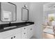 Dual sink bathroom vanity, modern faucets, decorative mirrors, and stylish lighting at 1054 Euclid Ne Ave, Atlanta, GA 30307