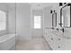Spacious bathroom featuring double sinks, white cabinetry, and modern black fixtures at 1054 Euclid Ne Ave, Atlanta, GA 30307