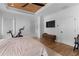 A well-lit bedroom features a striking wood ceiling, a ceiling fan, wood floors and a state-of-the-art exercise bike at 1054 Euclid Ne Ave, Atlanta, GA 30307