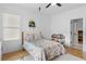 Bedroom with hardwood floors, ceiling fan, and a view into the hallway at 1054 Euclid Ne Ave, Atlanta, GA 30307