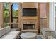 Comfortable outdoor living area with a brick fireplace, comfortable seating, and views of the surrounding landscape at 1054 Euclid Ne Ave, Atlanta, GA 30307