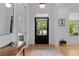 Bright foyer with hardwood floors, a modern mirror, and a view to the front door at 1054 Euclid Ne Ave, Atlanta, GA 30307