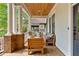 Relaxing front porch with ample seating, brick detailing, and a warm wood ceiling at 1054 Euclid Ne Ave, Atlanta, GA 30307