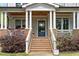 Inviting front porch with classic columns and brick accents, leading to the front door at 1054 Euclid Ne Ave, Atlanta, GA 30307