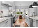 Bright, open-concept kitchen with stainless steel appliances, marble countertops, and view to eat-in nook at 1054 Euclid Ne Ave, Atlanta, GA 30307