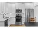 Modern kitchen featuring stainless steel appliances, white cabinetry, and sleek countertops at 1054 Euclid Ne Ave, Atlanta, GA 30307