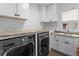 Bright laundry room with granite countertops, modern washer and dryer, ample cabinets, and a sink under the window at 1054 Euclid Ne Ave, Atlanta, GA 30307
