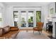 Bright living room with hardwood floors, fireplace, and french doors to the patio at 1054 Euclid Ne Ave, Atlanta, GA 30307