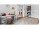 office with a sleek white desk, pink desk chair and bright, patterned rug over hardwood floors at 1054 Euclid Ne Ave, Atlanta, GA 30307