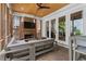 Inviting screened-in patio with a brick fireplace, plush seating, a ceiling fan, and a view of the backyard at 1054 Euclid Ne Ave, Atlanta, GA 30307
